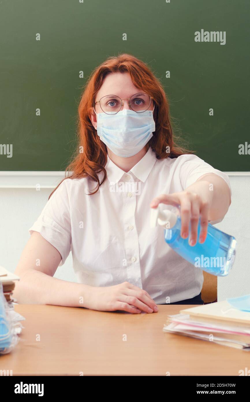 The school doctor is cleaning his hands with antibacterial soap