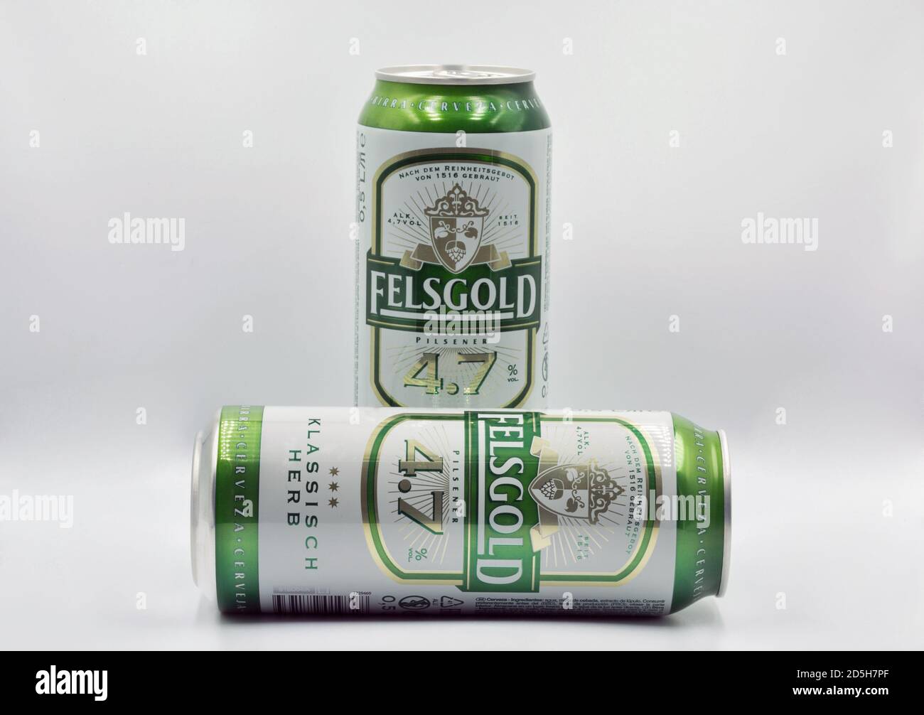 KYIV, UKRAINE - JULY 23, 2020: Felsgold Klassisch Herb German pilsner beer cans closeup against white bacground, focus on foreground. Stock Photo