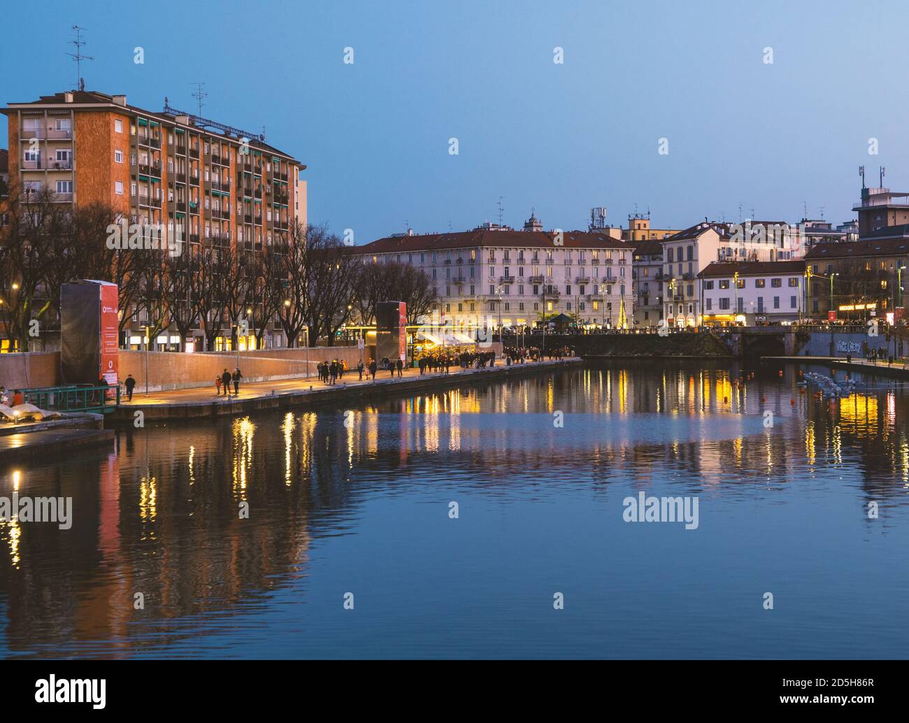 Stunning blue hour view of Darsena in the touristic district of Milan. Large body of water where the lights of the city are reflected. Lombardy, Italy Stock Photo