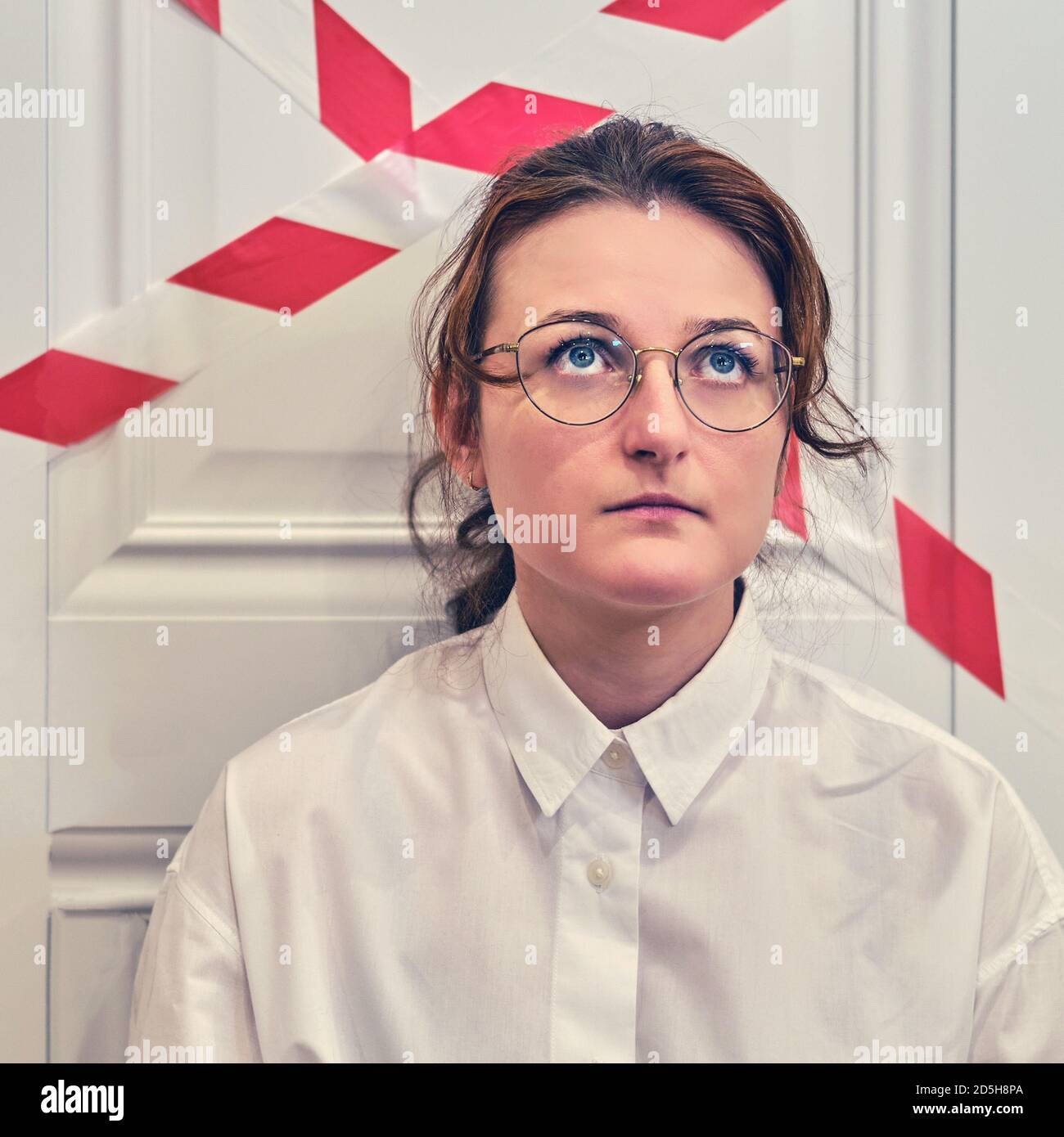 Woman sad in front of closed office door, concept of work problems due