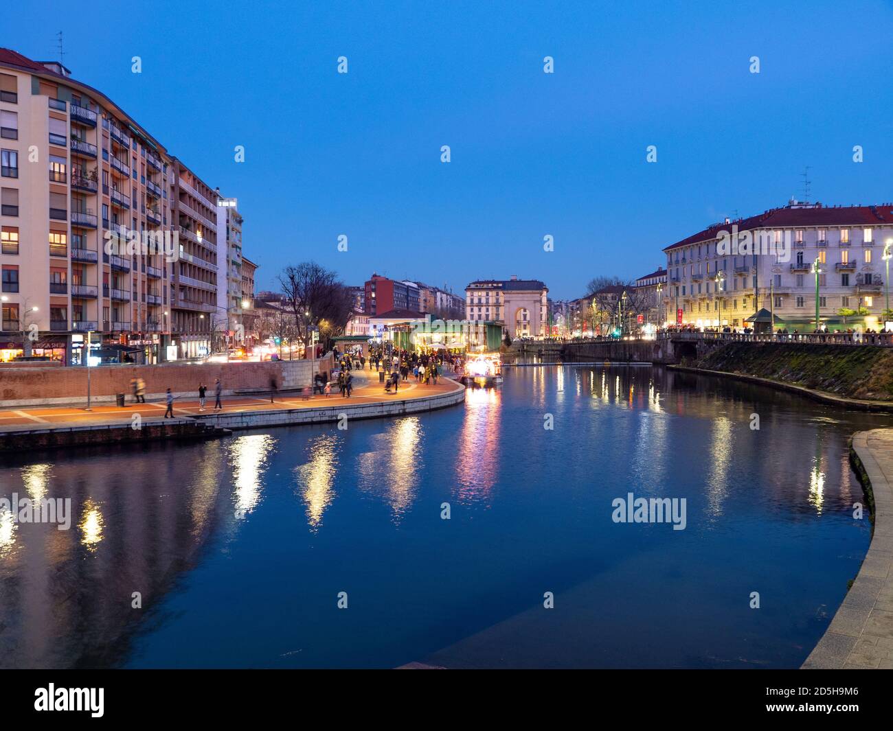 Beautiful view of Darsena in the touristic district of Milan during the blue hour and the lights of the city can be seen reflected on the water.Lombar Stock Photo