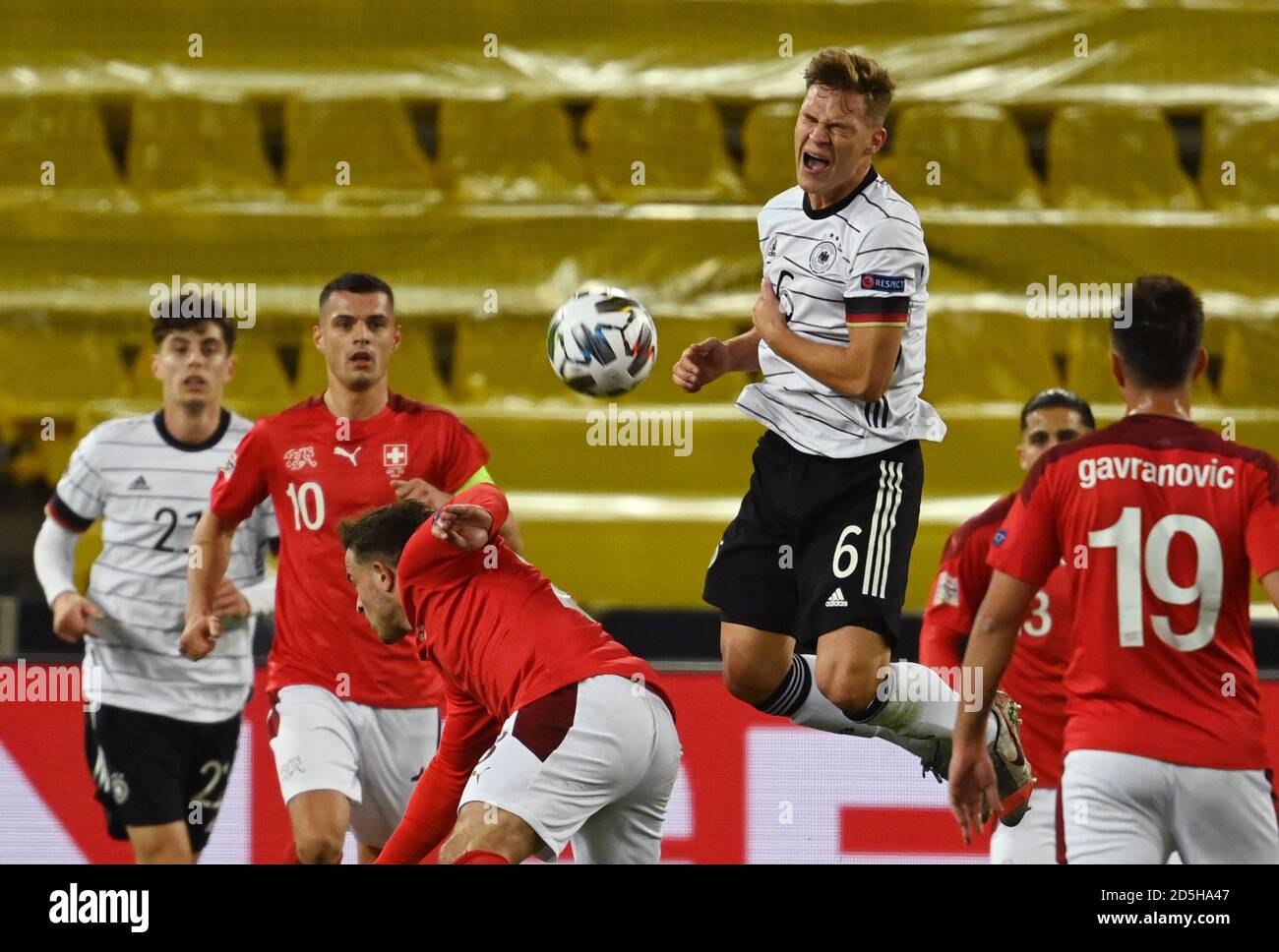 Cologne, Germany. 13th Oct, 2020. Football: Nations League A, Germany -  Switzerland, group stage, group 4, 4th matchday at the RheinEnergieStadion.  Germany's Joshua Kimmich (r) and the Swiss Xherdan Shaqiri fight for