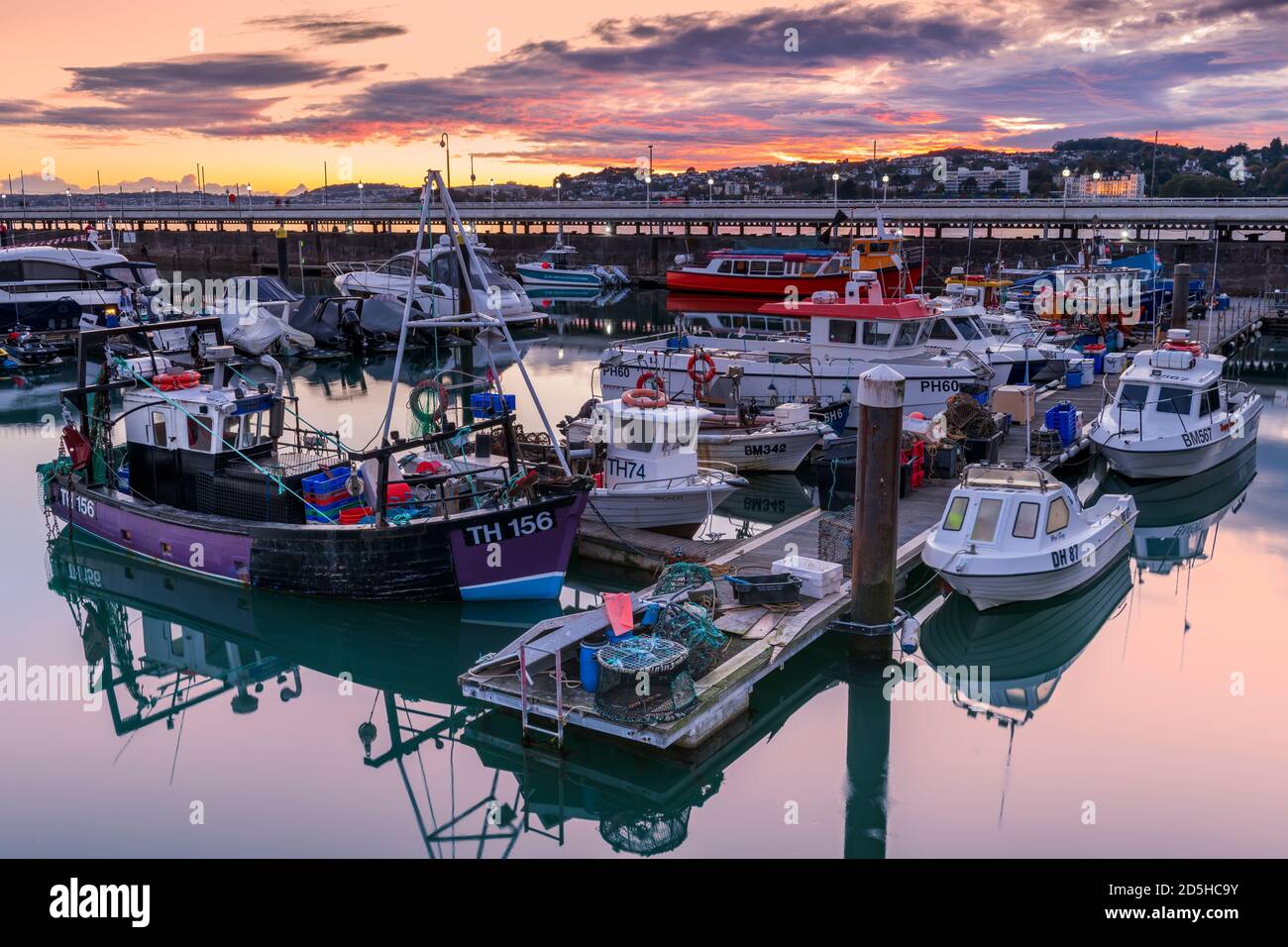 Tuesday 13th October 2020. Torquay, South Devon, England. After a day of sunshine and showers on the south coast, as the sun sets a colourful sky lights up the calm waters of the marina at Torquay on 'The English Riviera' in South Devon. Credit: Terry Mathews/Alamy Live News Stock Photo
