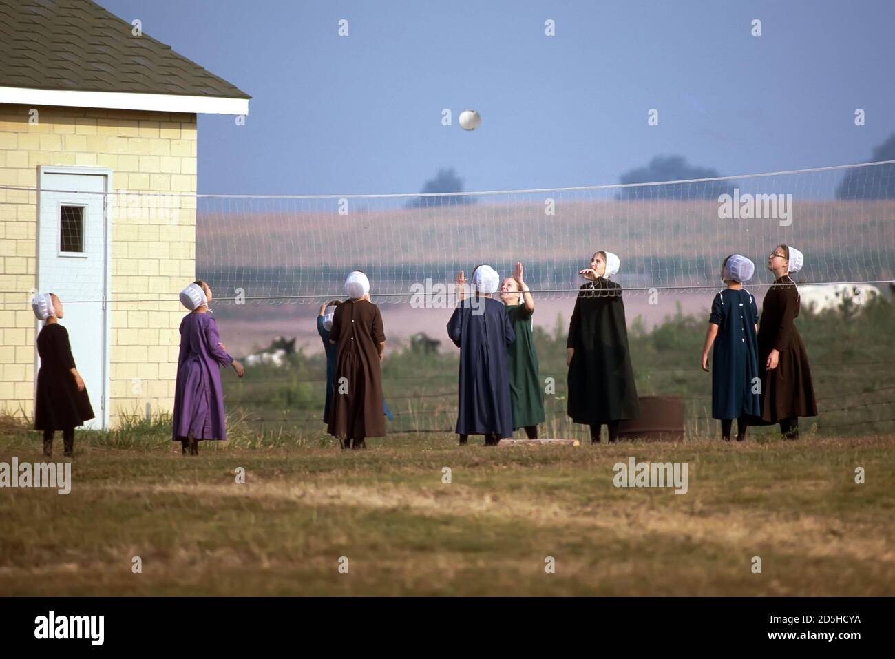 Amish school girls play volleyball in a school yard - Shipshewana - Indiana Stock Photo