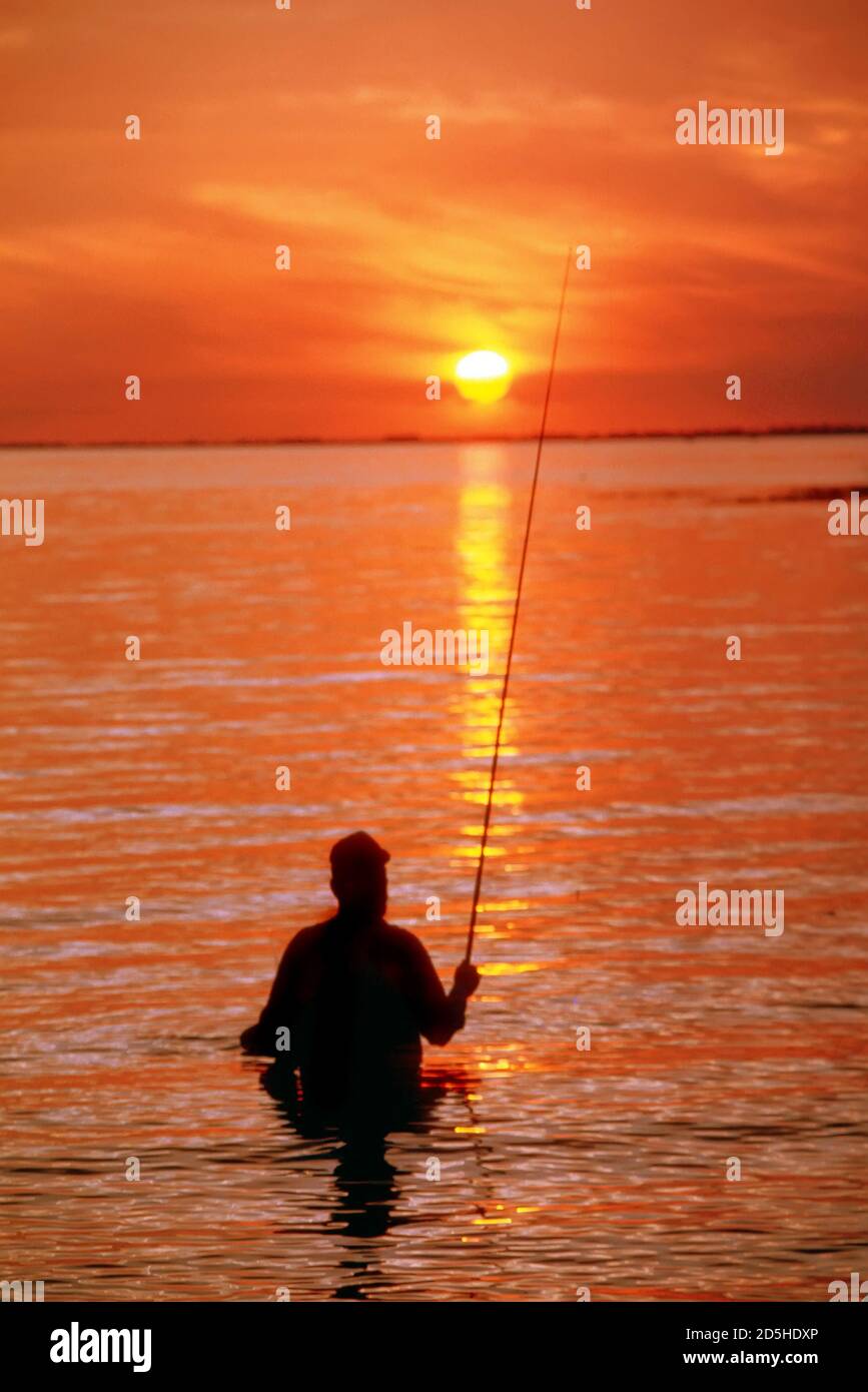 Fly rod fishing at sunset on Lake Okeechobe, Florida Stock Photo