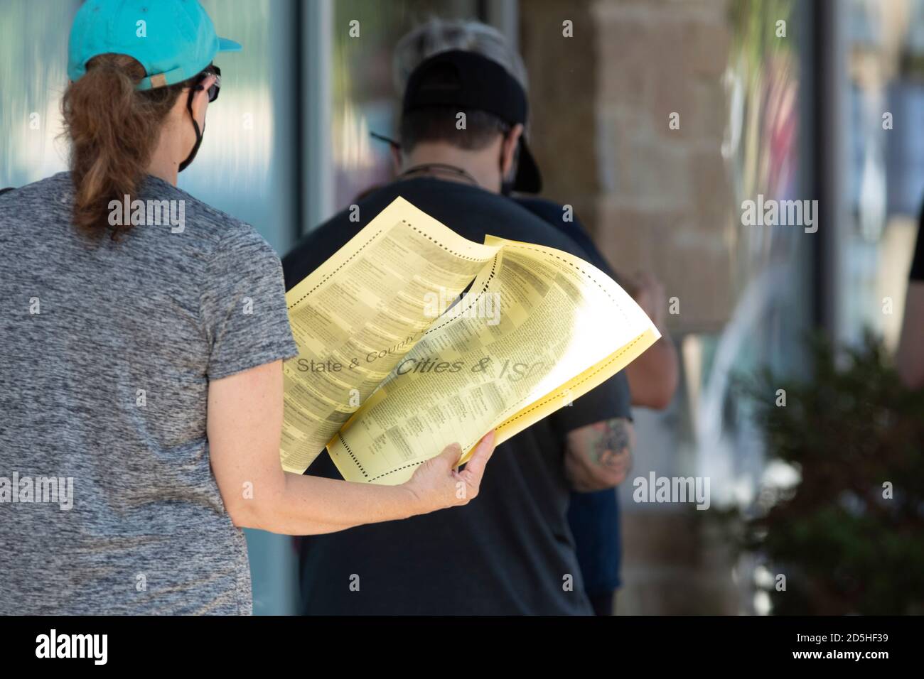 Austin, Texas, USA. 13th Oct, 2020. A woman holds a sample ballot as