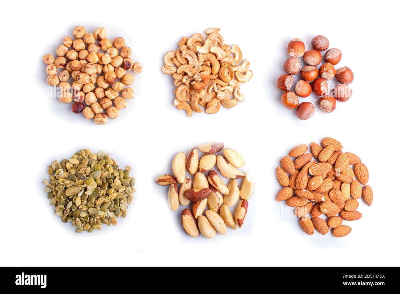 Piles of various nuts and seeds isolated on white background. hazelnut