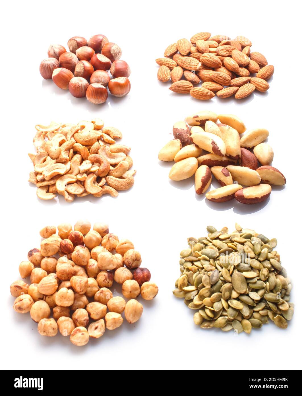Piles of various nuts and seeds isolated on white background. hazelnut