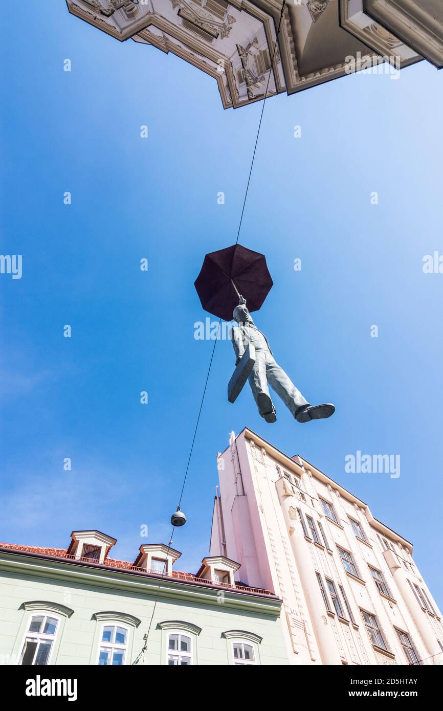 Praha: sculpture Man With An Umbrella hanging on rope between 2 houses,  businessman in Nove Mesto, New Town, Praha, Prag, Prague, Czech Stock Photo  - Alamy