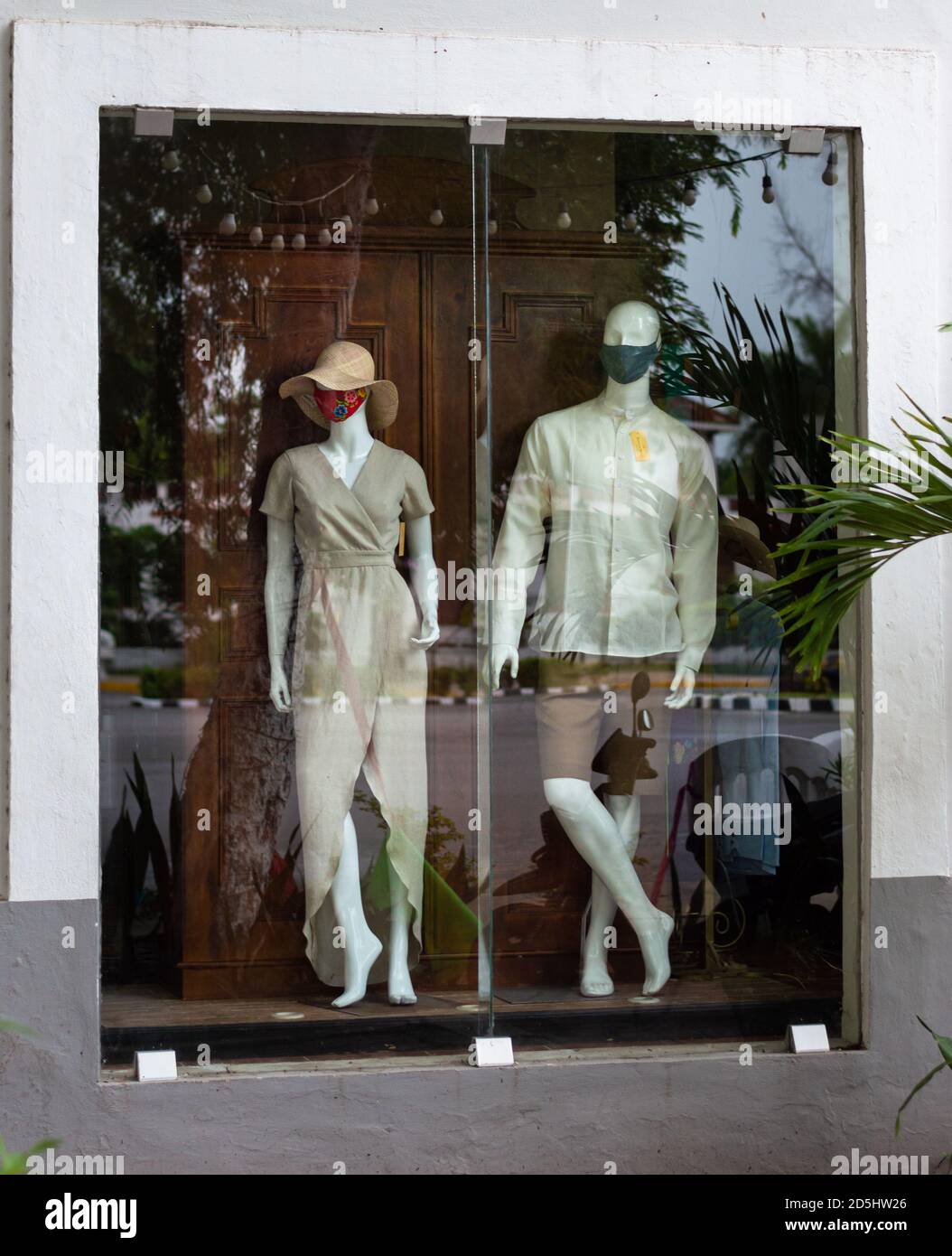 Covid 19 Pandemic in Mexico, New normal trends. Boutique in Merida, Yucatan, mannequins wearing Mexican fashion and face masks in a touristy area. Stock Photo