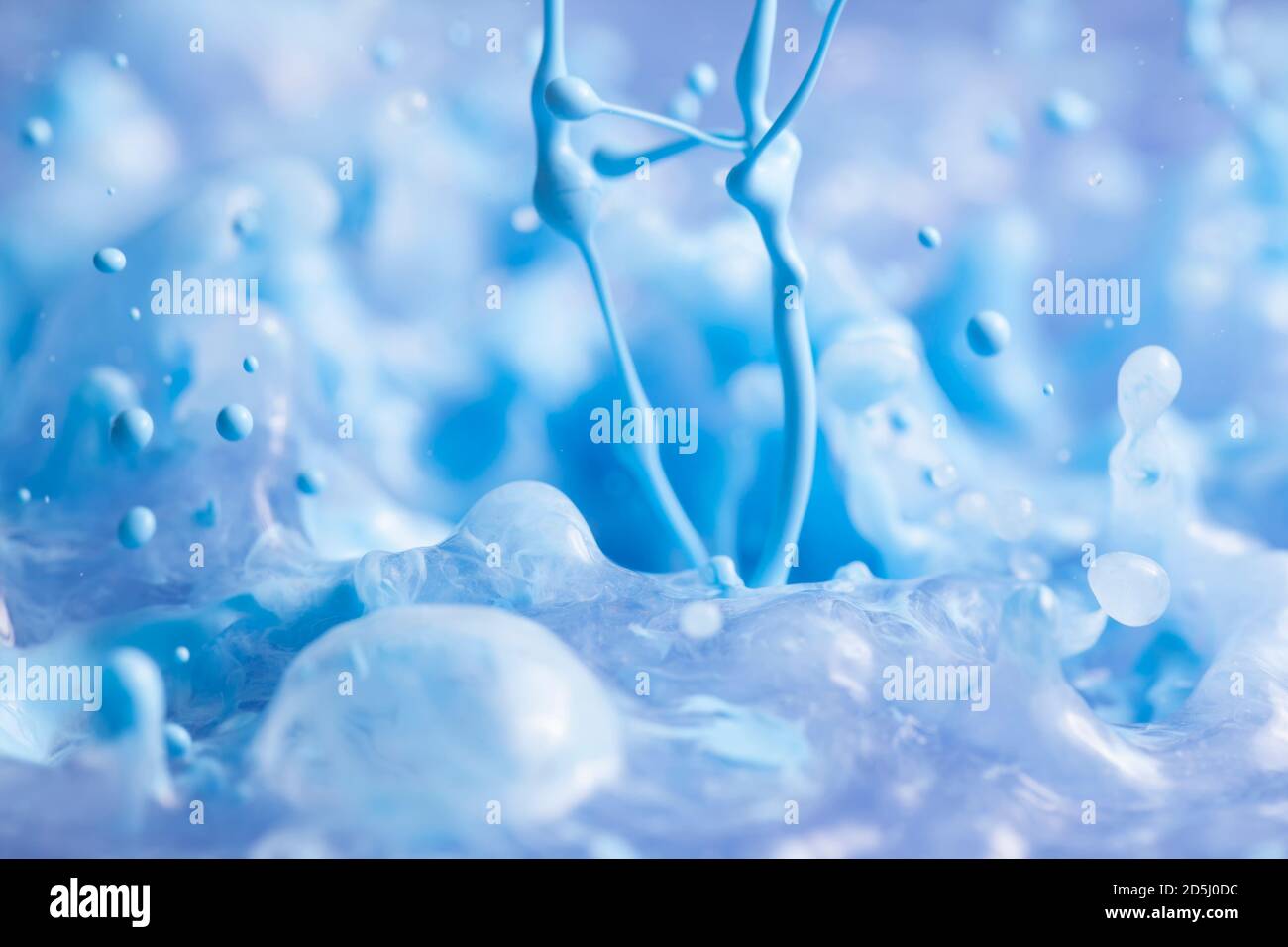 Blue paint splashing creating lots of paint bubbles and droplets. Stock Photo