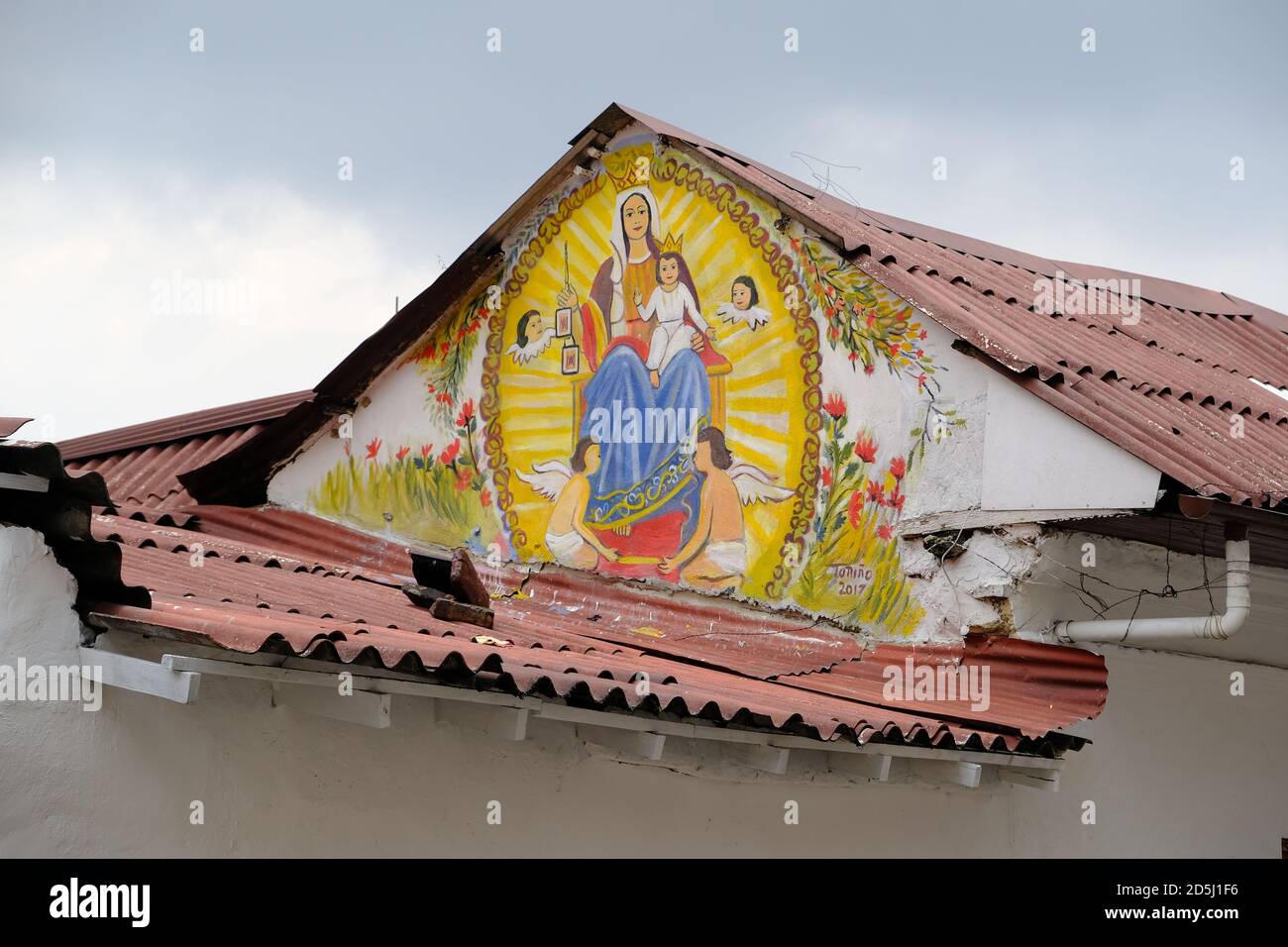 Colombia Bogota - Historic town area house facade with religious street wall painting Stock Photo