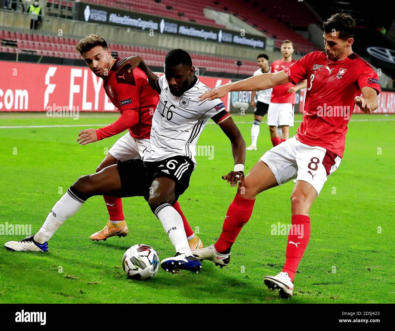 Cologne. 14th Oct, 2020. Antonio Ruediger (C) of Germany vies with Xherdan Shaqiri (L) and Remo Freuler of Switzerland during their UEFA Nations League match in Cologne, Germany, Oct. 13, 2020. Credit: Xinhua/Alamy Live News Stock Photo