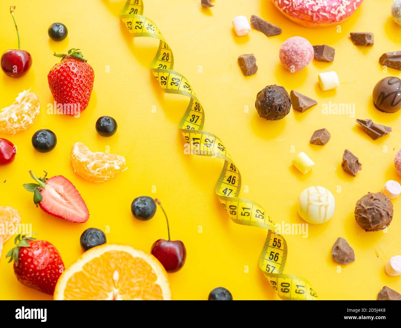 Healthy vs unhealthy dessert, dieting concept. Blueberries strawberries