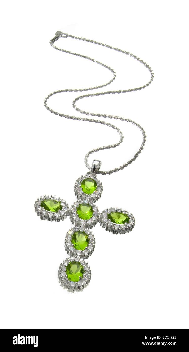 Peridot green cross necklace encrusted with diamonds photographed on a white background Stock Photo