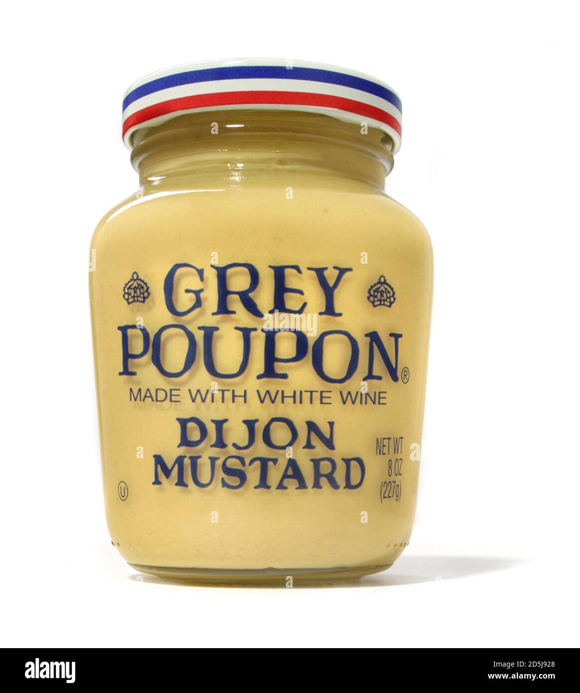 A closed jar of grey poupon dijon mustard photographed on a white