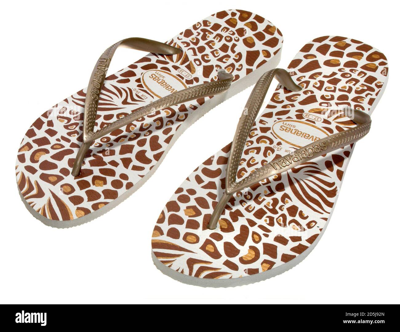 brown and gold animal print havaianas flip flops photographed on a white background Stock Photo