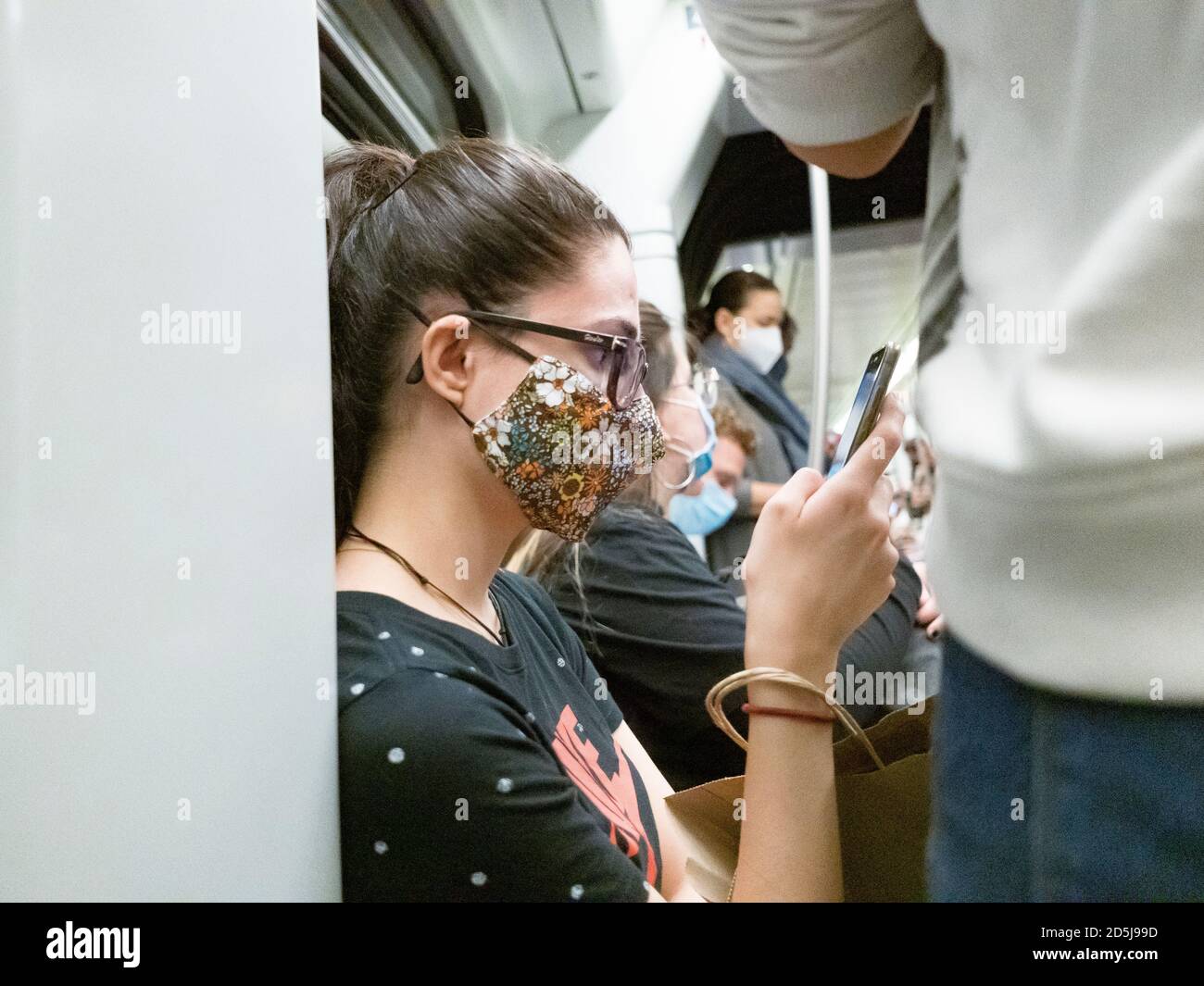 Valencia, Spain. 13th Oct, 2020. Passengers wearing face masks sit in the subway train car at Angel Guimerá Station. Credit: SOPA Images Limited/Alamy Live News Stock Photo