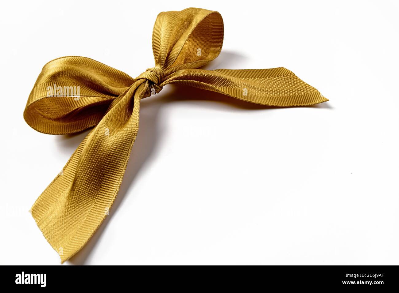 Golden gift bow on white background Stock Photo