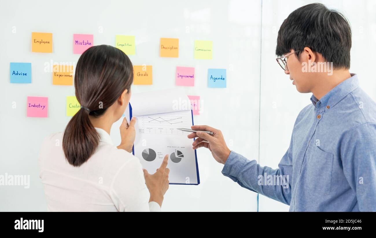 business teamwork in meeting and adhesive stick note on mirror board discus...