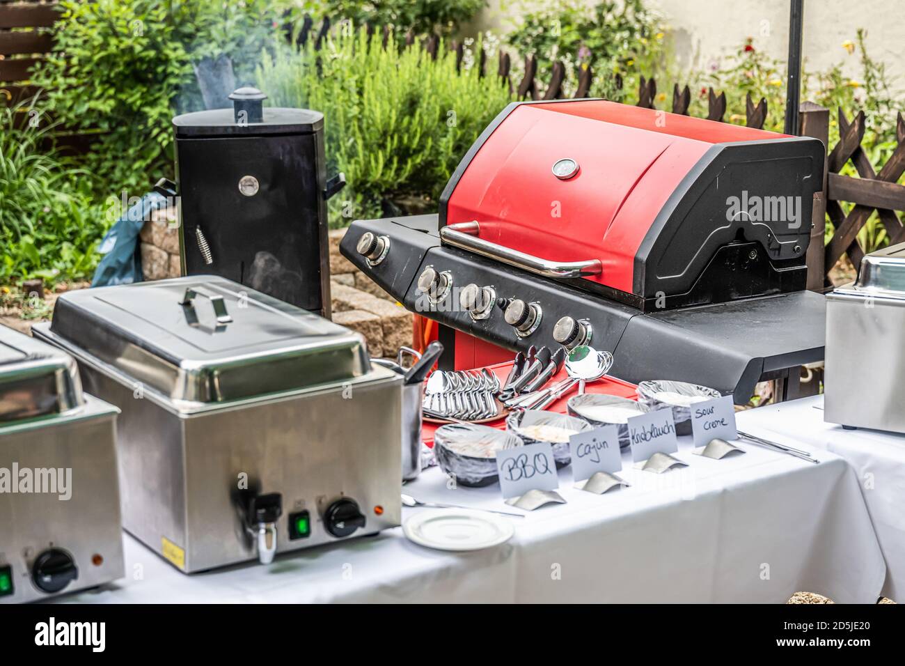 Large barbecue grill and smoker setup with sauces grilling meat bbq