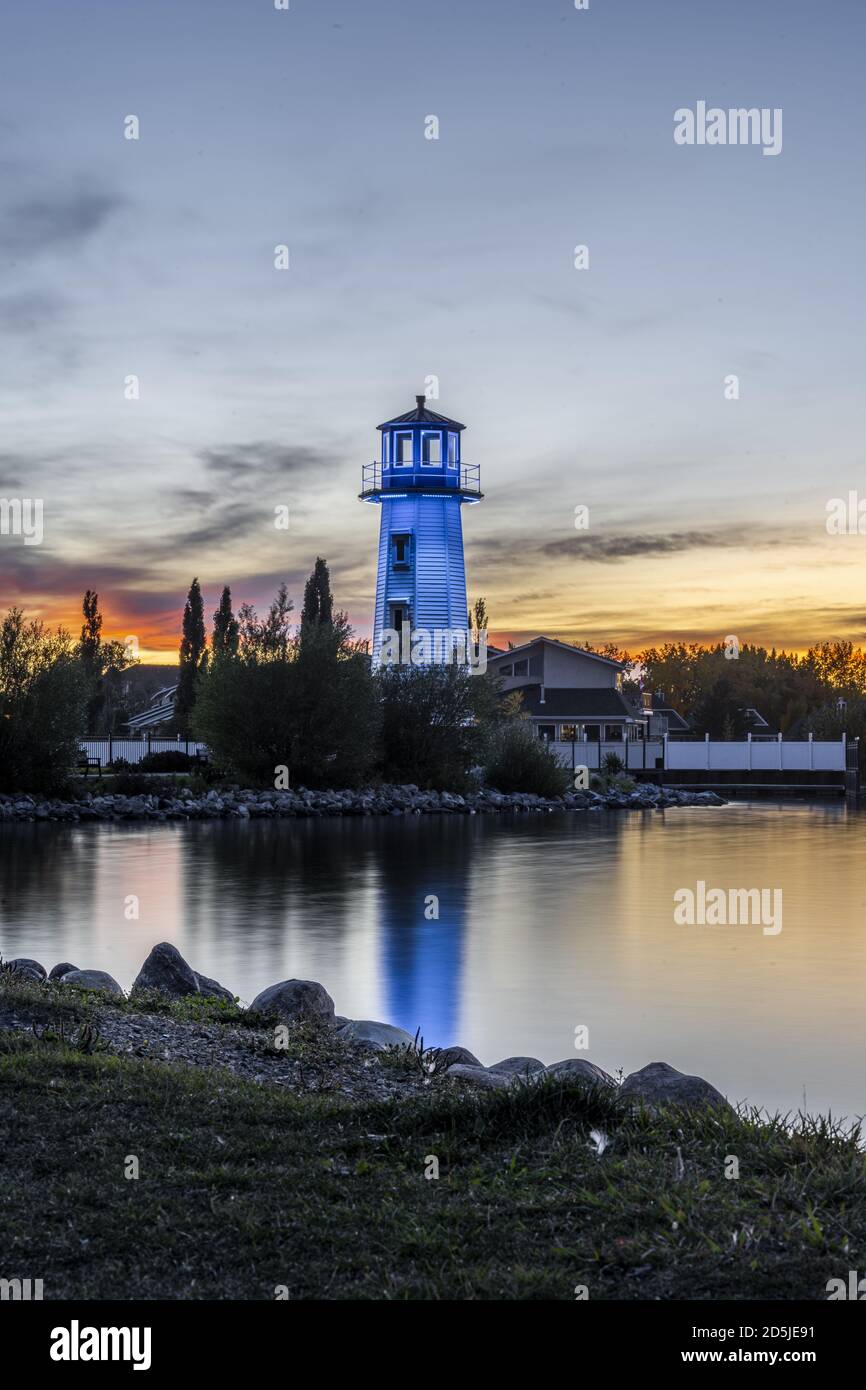 Vertical shot of a blue lighthouse near the shore of Sylvan Lake in Alberta, Canada Stock Photo