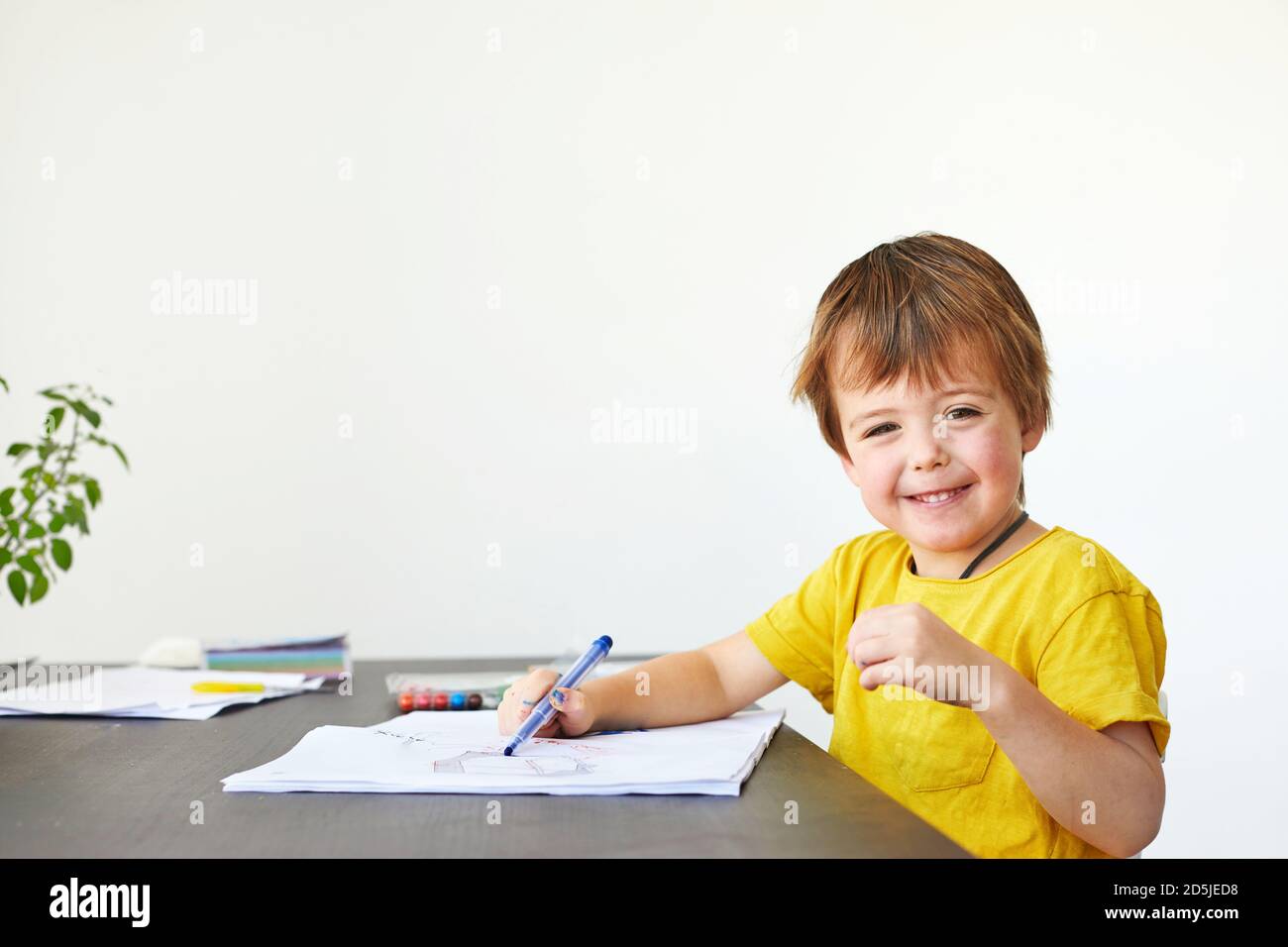 Happy kid drawing in sketchbook Stock Photo