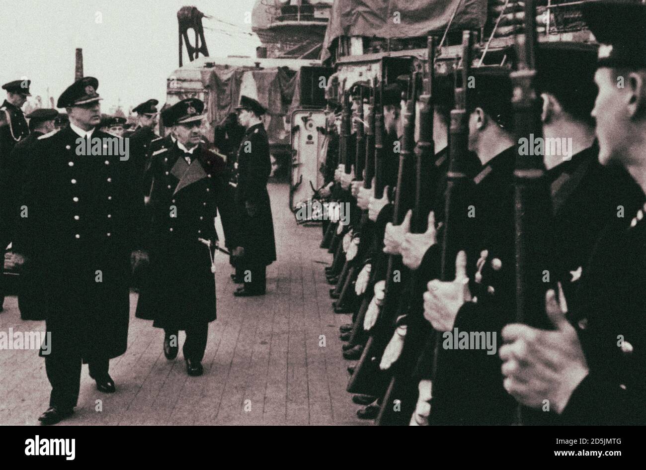 Visit of Grand Admiral Kriegsmarine Erich Raeder to the “Scharnhorst” battleship of the Nazi Kriegsmarine. Next to German Admiral Raeder is the comman Stock Photo