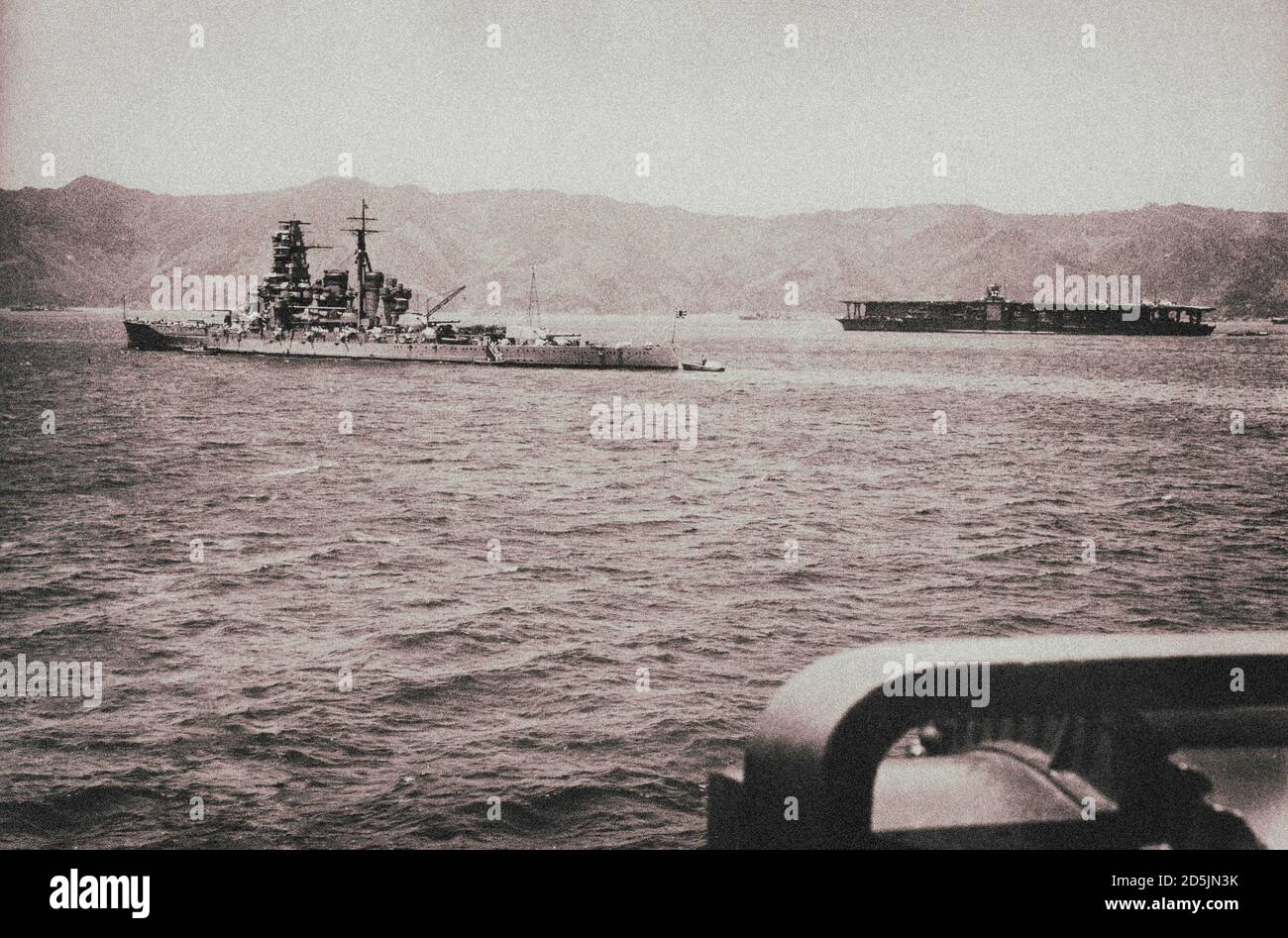 Japanese cruiser “Kirishima” and aircraft carrier “Akagi” in the bay Tsukumowan, Japan. April 27, 1939 Stock Photo
