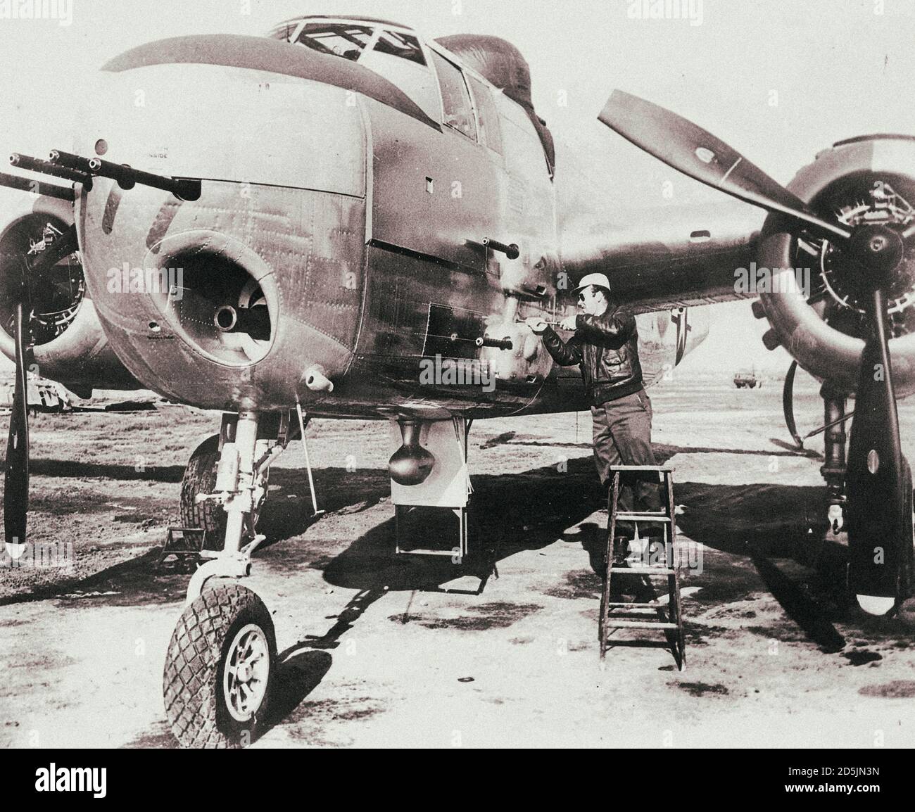 USAF North American B-25 Mitchell twin-engine bomber with Browning M2 machine guns of 12.7 mm caliber and 75 mm cannon during maintenance. Stock Photo