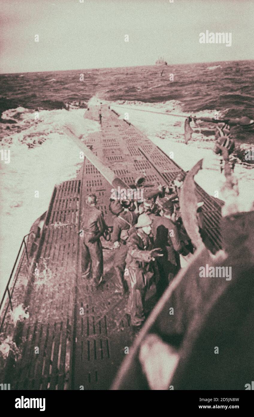 Archival photo of artillerymen of the German submarine U-123 of the Nazi Kriegsmarine are preparing for firing a 10.5 mm L/45 cannon on the transport Stock Photo