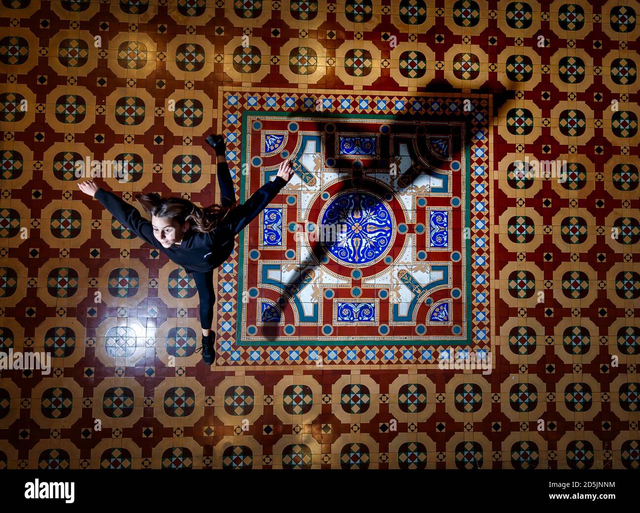 Isla McGee plays on a historic George and Arthur Maw tiled floor created in 1867, one of only two surviving examples of this assemblage of tiles, during a photocall at England's oldest living convent Bar Convent. Visitors to the convent are being invited to follow in the footsteps of residents from the last 150 years and enjoy the historic space decorated with rare 19th century floor tiles. Stock Photo