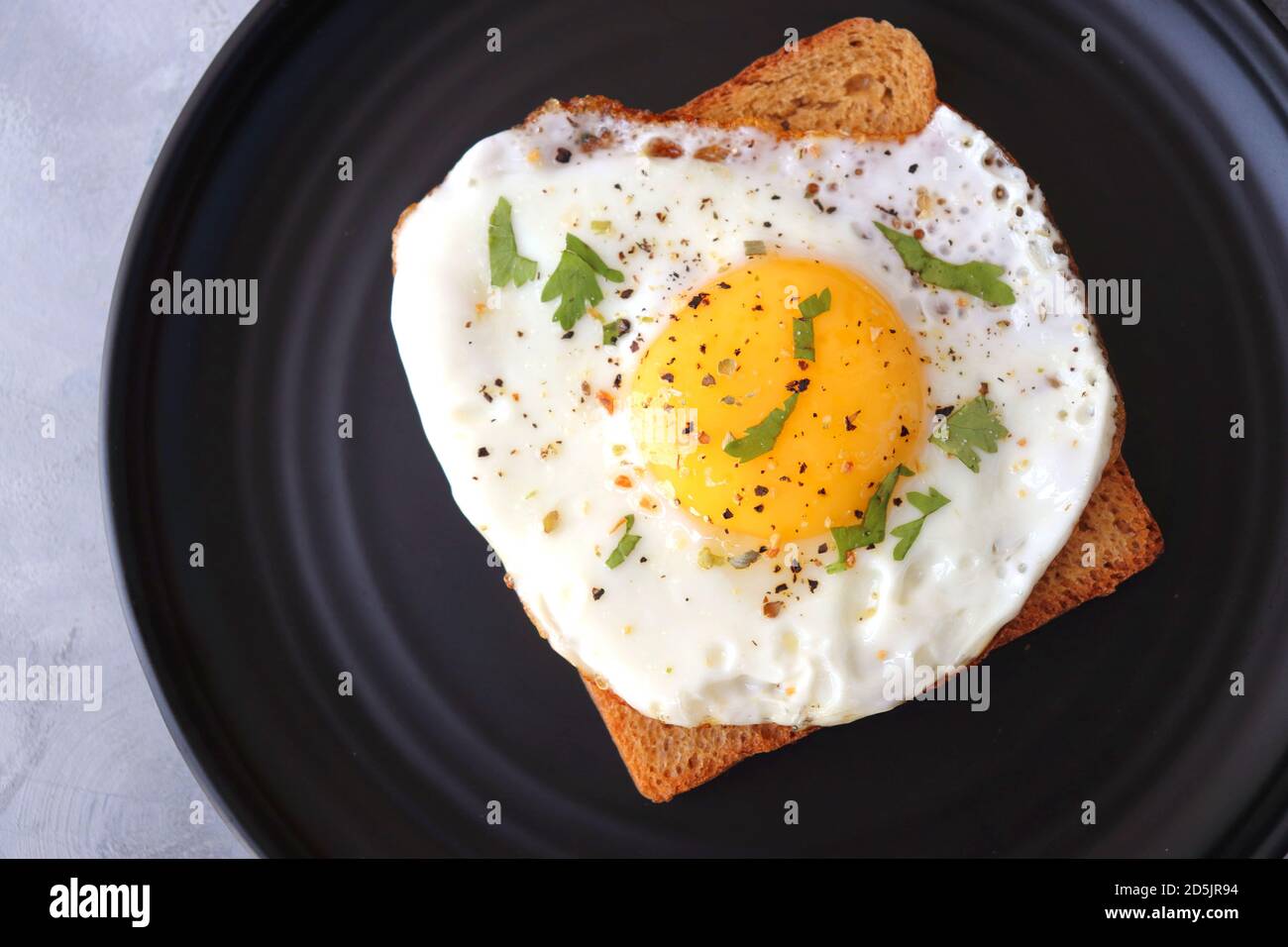Fried Egg on Whole wheat Toast with salt and pepper for classic
