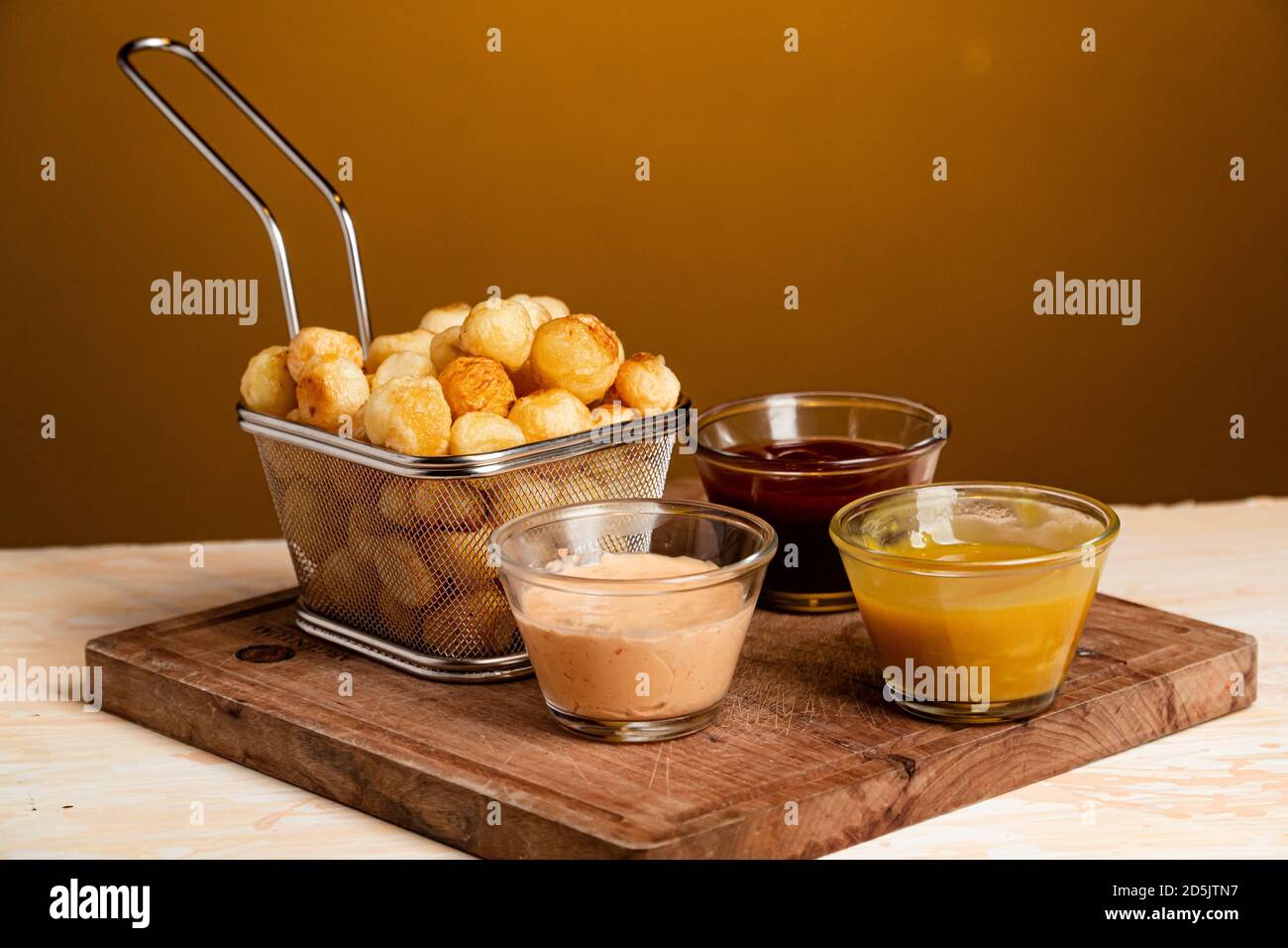 Closeup shot of Noisette potatoes with various sauces shot of Stock Photo