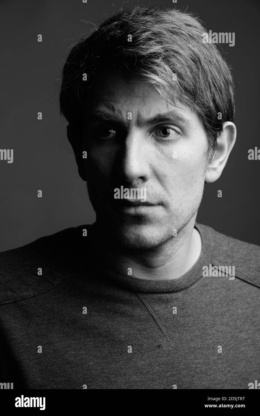Portrait of handsome man against gray background Stock Photo - Alamy