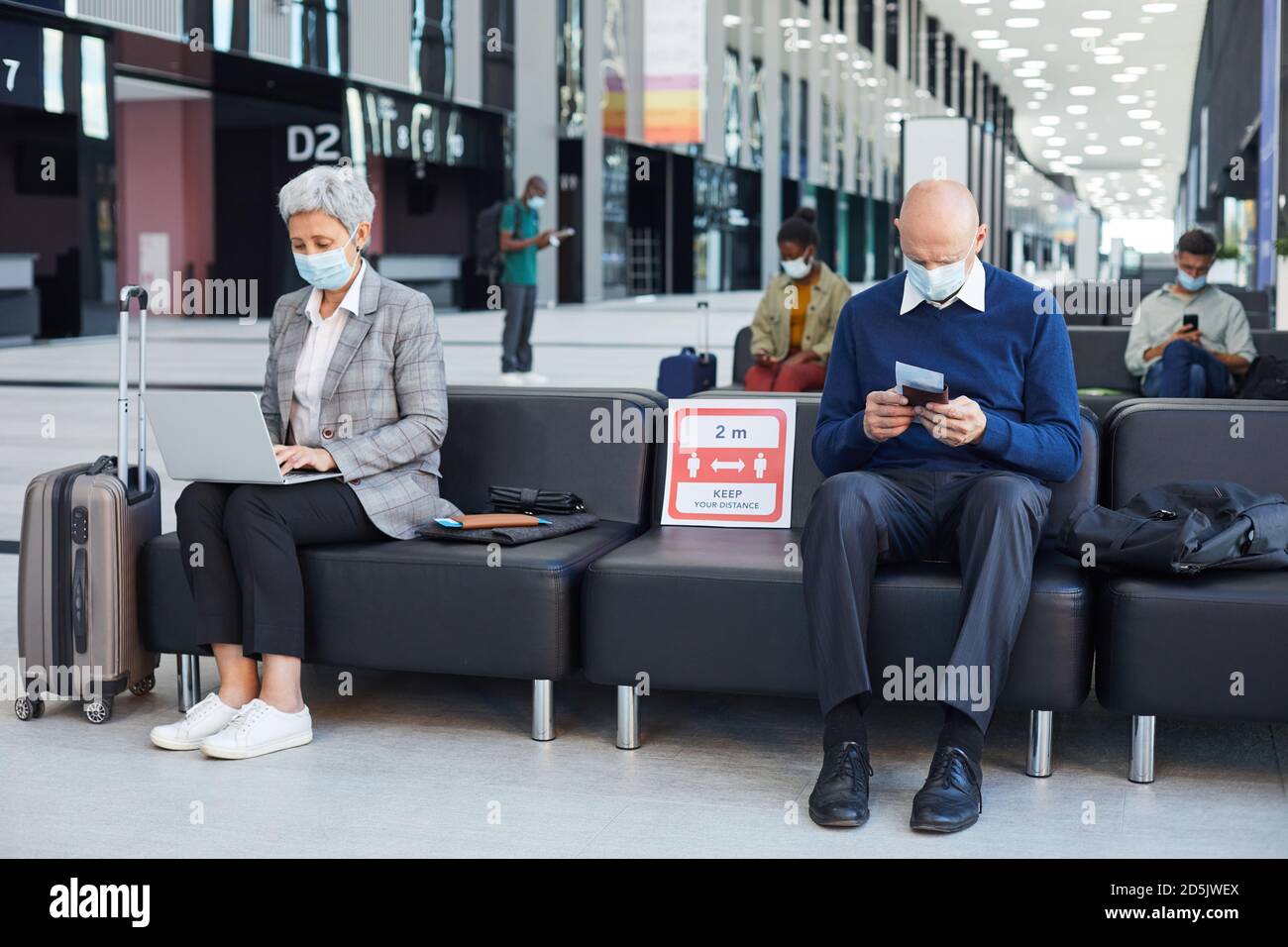 Group of people in masks sitting in waiting room they keeping social ...
