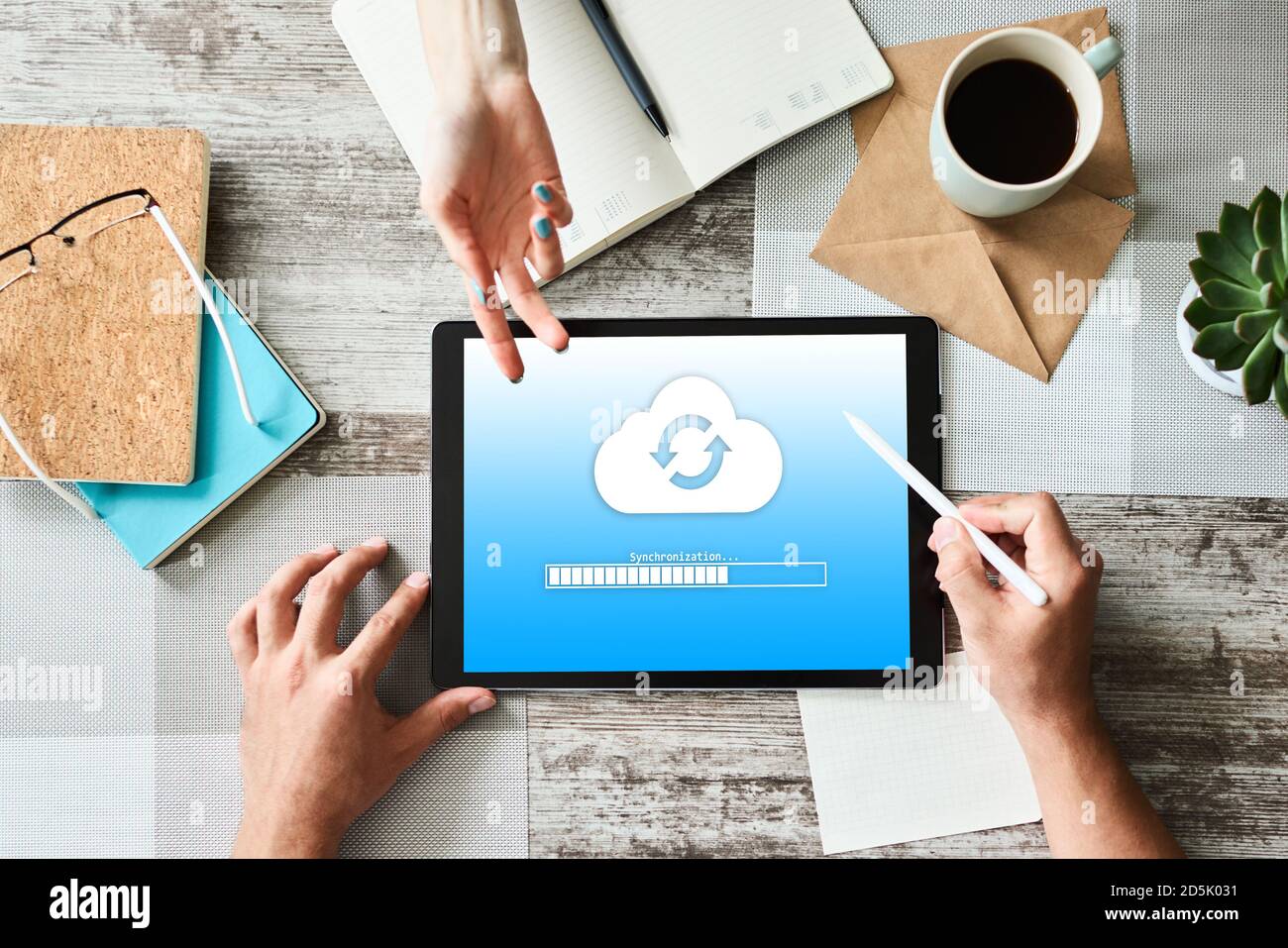 Cloud synchronization progress bar on tablet screen. Data storage and protection. Technology and internet concept Stock Photo