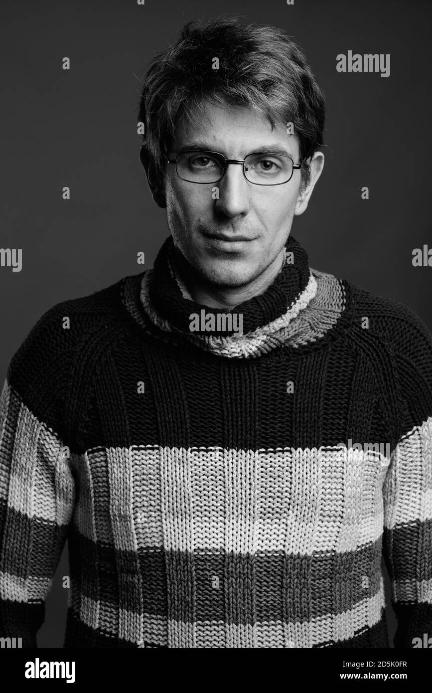 Handsome man wearing eyeglasses against gray background Stock Photo