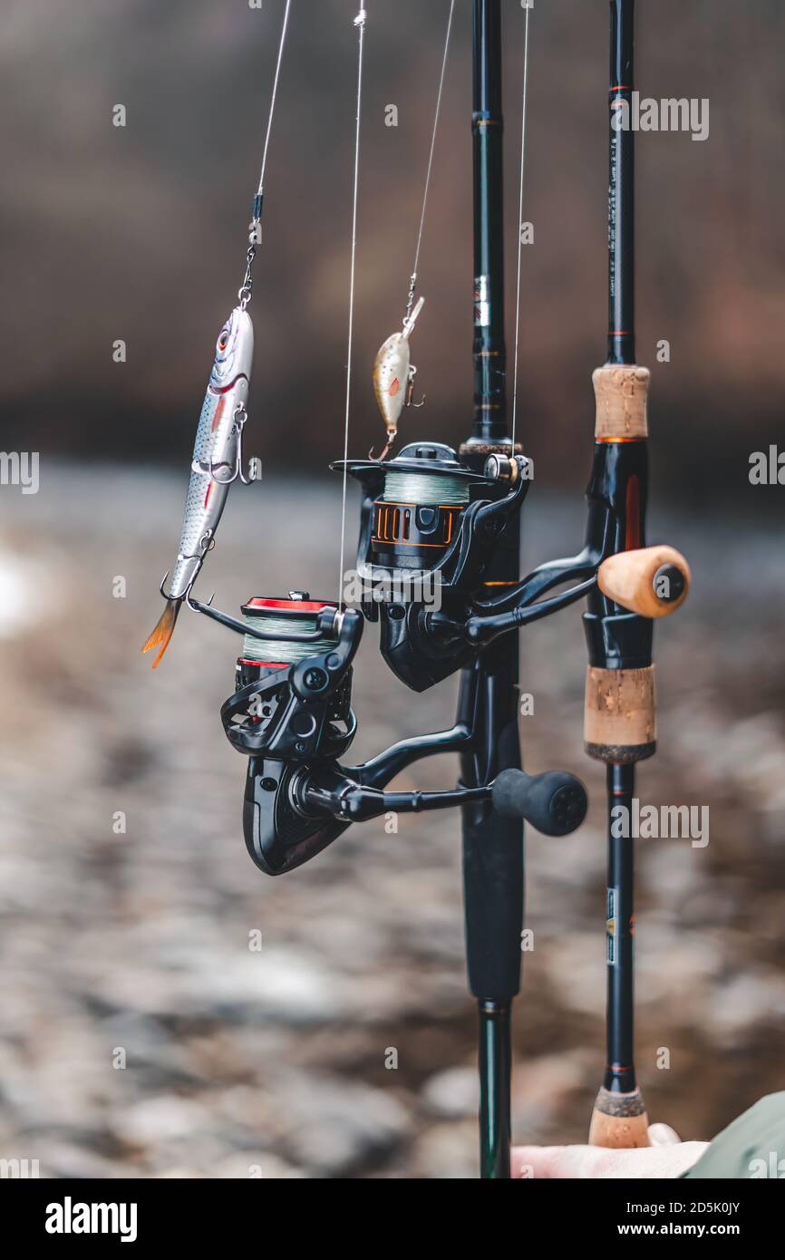 Fishing tackle, rod, reel and baits in with background Stock Photo