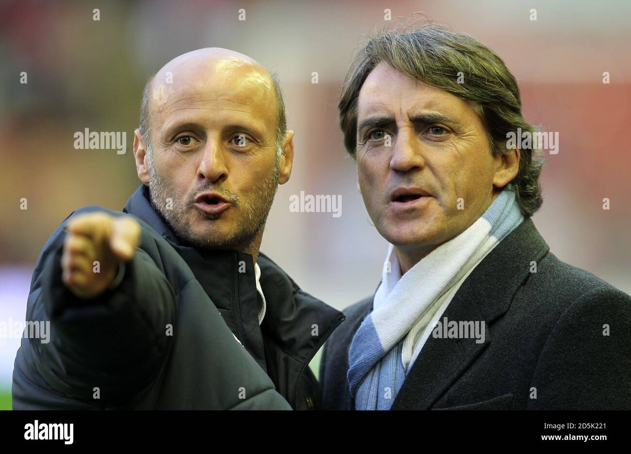 Manchester City manager Roberto Mancini (right) and coach Attilio Lombardo on the touchline before kick off Stock Photo