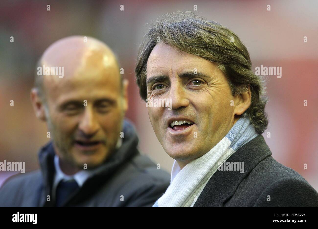 Manchester City manager Roberto Mancini (right) and coach Attilio Lombardo on the touchline before kick off Stock Photo