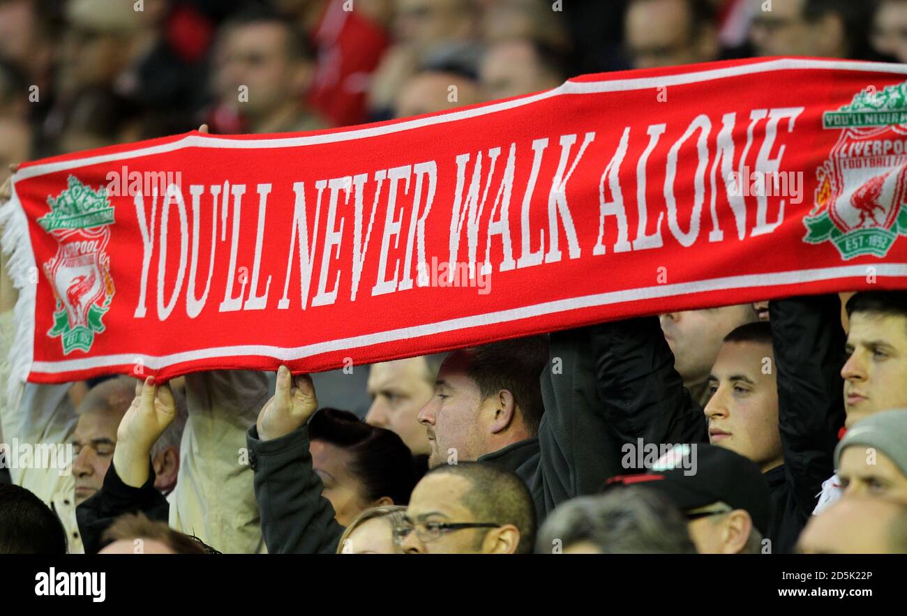 Liverpool fans display a scarf in the stands with the words You'll Never Walk Alone as they take part in a minute's silence in memory of the HIllsborough disaster Stock Photo