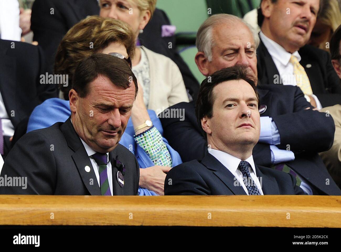Chancellor of the Exchequer George Osborne and All England Club chairman Philip Brook watch the match between Switzerland's Roger Federer and France's Jo Wilfried Tsonga from the royal box on day nine of the 2011 Wimbledon Championships at the All England Lawn Tennis and Croquet Club, Wimbledon. Stock Photo