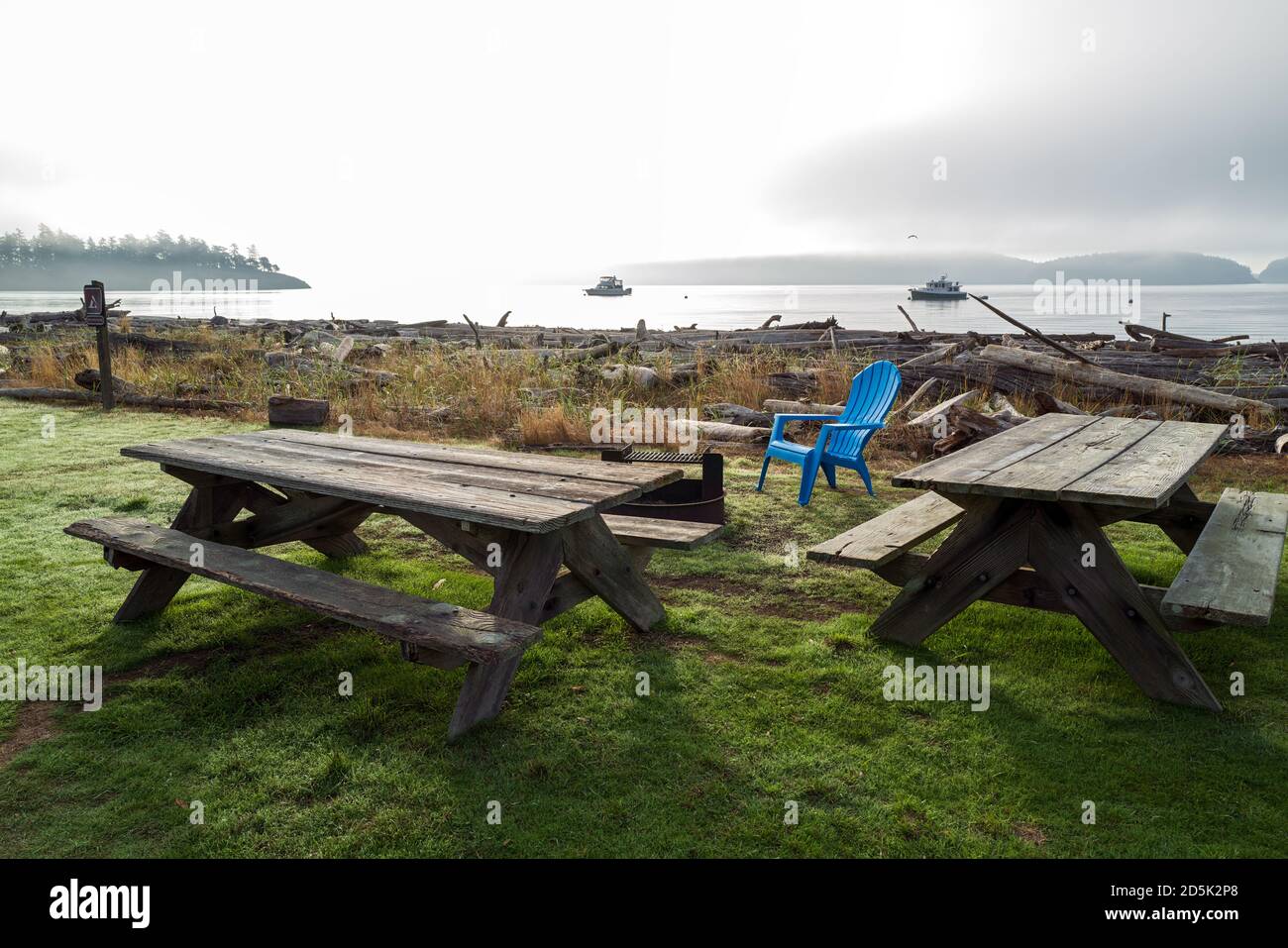 Picnic tables and a blue chair at Spencer Spit State Park on Lopez