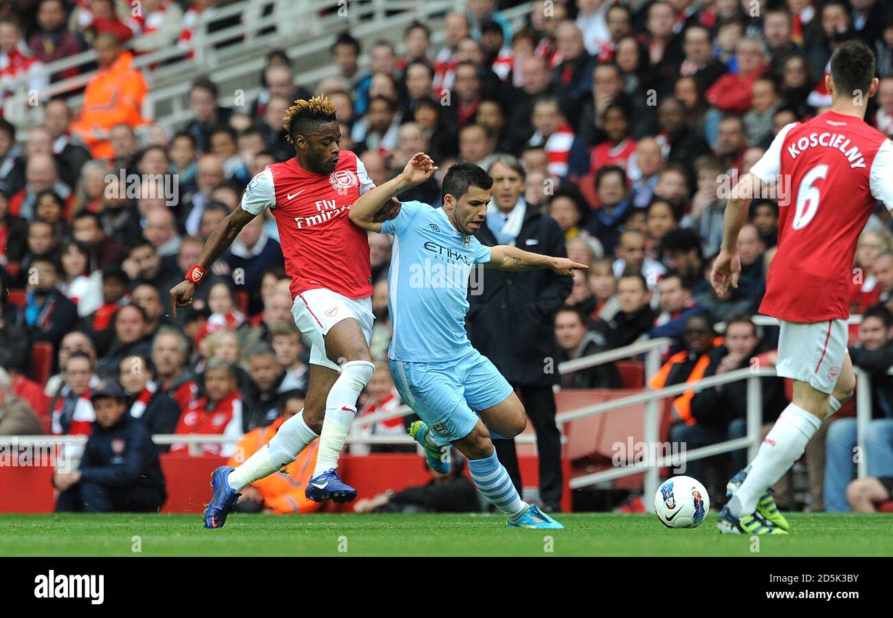 Manchester City's Sergio Aguero (right) and Arsenal's Alex Song (left) battle for the ball Stock Photo