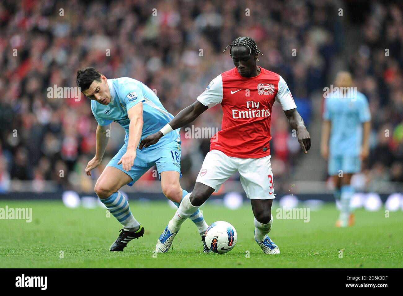Arsenal's Bacary Sagna (right) and Manchester City's Gareth Barry (left) battle for the ball Stock Photo