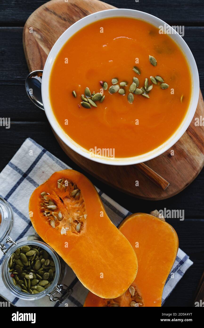 Top view of pureed pumpkin soup in a white bowl on dark table Stock ...