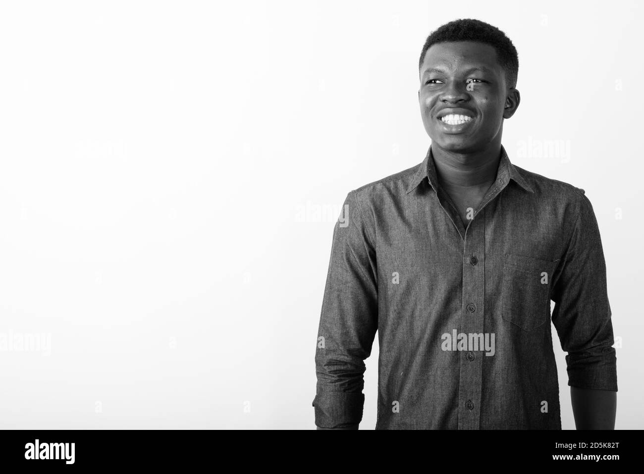Portrait of happy young African man thinking Stock Photo - Alamy