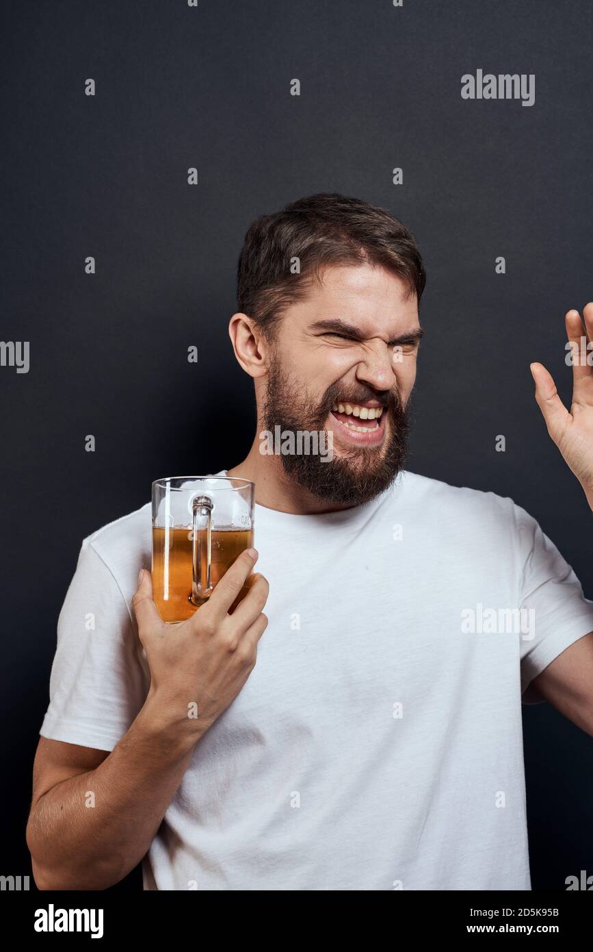 man with a mug of beer in a white tshirt emotions lifestyle drunk on a
