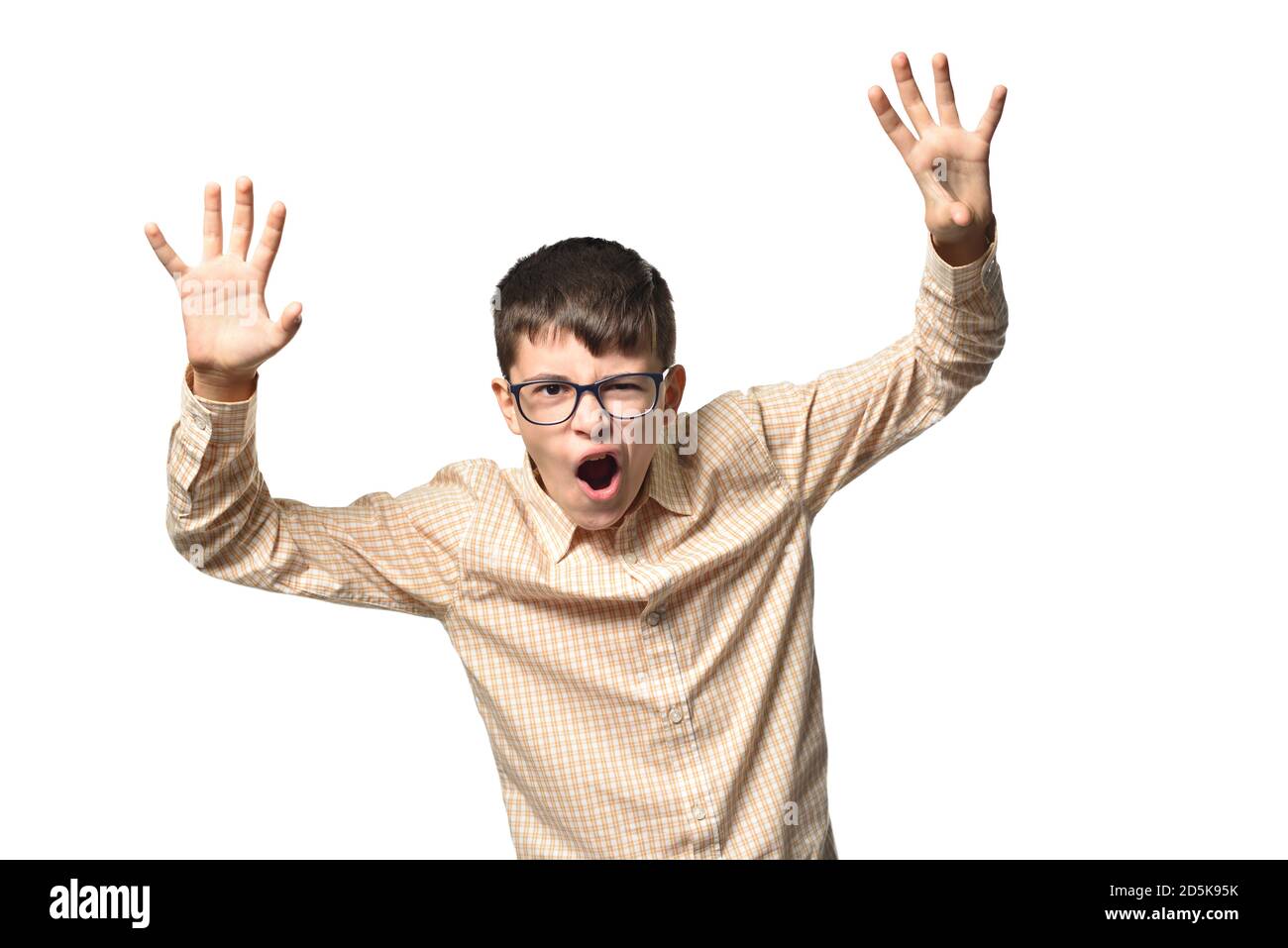 Cheerful boy of 13 years old, shows himself as a terrible monster and causes fright Stock Photo